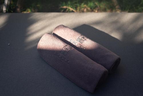 a pair of socks sitting on top of a table at The Sirocco Villas Bingin by Sandara in Bingin Beach
