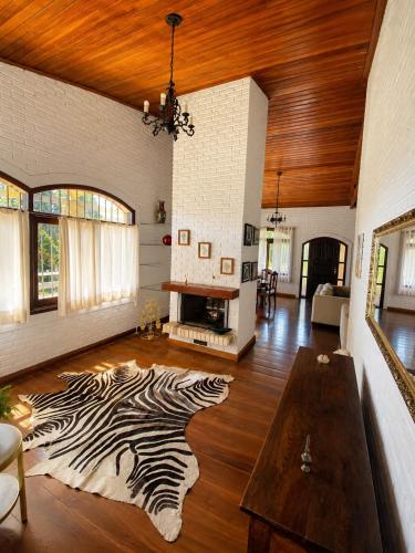 a living room with a zebra rug on the floor at Pousada Sítio das Cerejeiras in São Roque
