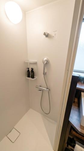 a shower stall with a shower head in a bathroom at Pleasure Resort Izu Akazawa Onsen in Ito