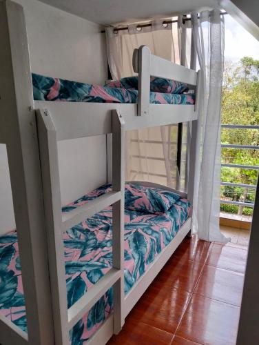 a couple of bunk beds in a room with a window at Gigi's transient house in Baguio