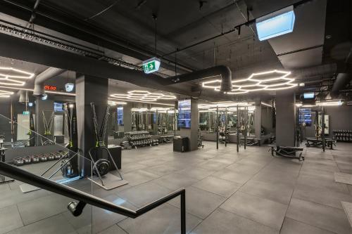 a gym with several treadmills and machines at Urban Rest Melbourne in Melbourne