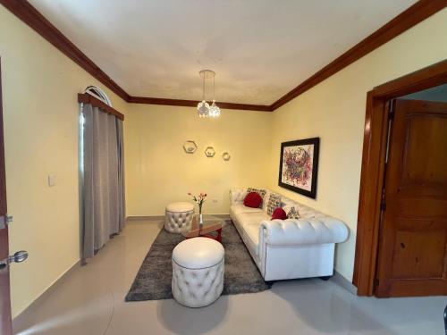 a living room with a couch and a table at Aparta hotel doble in Higuey
