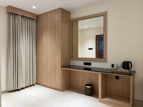a room with a vanity with a mirror and a mirror at M Convention Eluru in Elūru