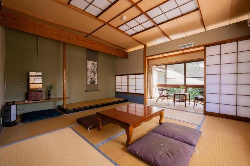 a living room with a table and a couch at guesthouse LAPPY in Ureshino