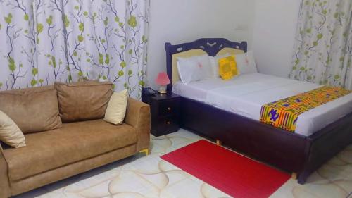 a living room with a bed and a couch at Excel Roses Hotels in Kontrajeso