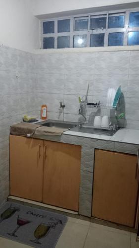a kitchen with a sink and a counter top at Cess cozy stay maua in Maua