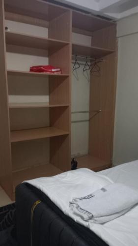 a bedroom with a bed and a book shelf at Cess cozy stay maua in Maua