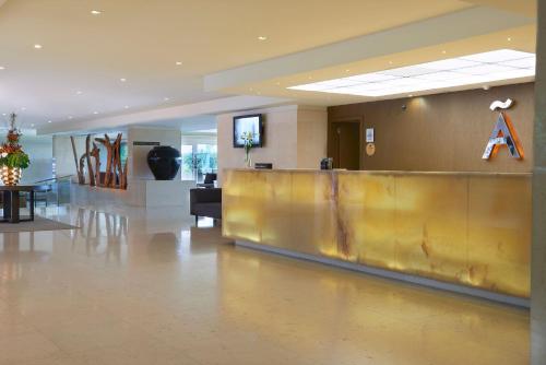 a lobby with a reception desk in a building at Meliá Madeira Mare in Funchal