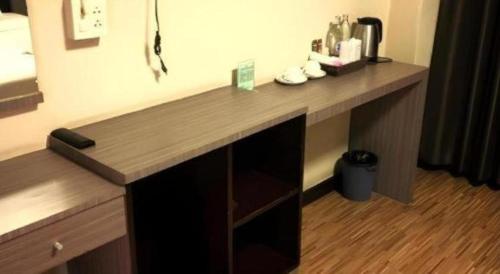 a desk in a hotel room with a wooden counter top at V51 Hotel in Ban Hua La Loeng