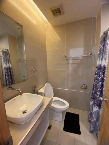 a bathroom with a sink and a toilet and a shower at Jeffrey S Hotel in Boracay