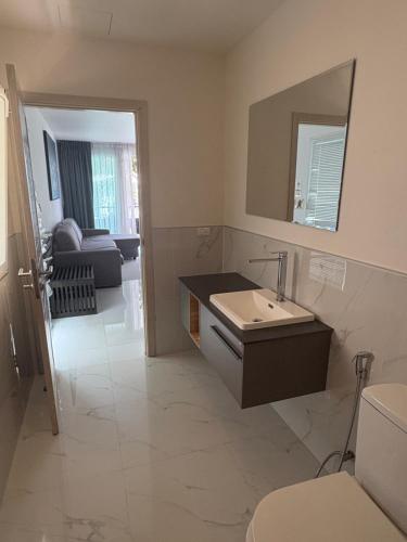 a bathroom with a sink and a toilet and a mirror at Karon Butterfly Condominium Brandnew 68m2 apartment, seaview, pool access, 500m to beach in Karon Beach
