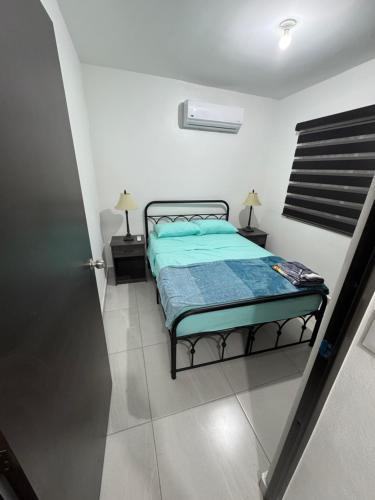 a bedroom with a bed and two night stands at TadeoHouse in Tijuana
