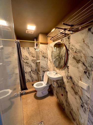 a bathroom with a toilet and a sink at 2BR Burnham Hill Condominium in Baguio