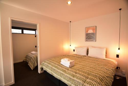 a hotel room with a bed and a window at Simply Stunning Stars A in Lake Tekapo