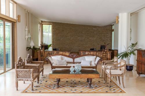 a living room with couches and tables and chairs at Meliá Zanzibar in Kiwengwa