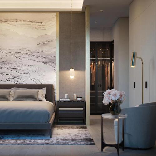 a bedroom with a bed and a vase of flowers at Filmores Hotel in Toronto