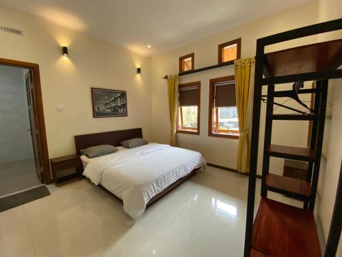 a bedroom with a bed and a bunk ladder at Villa New IMS in Bandung