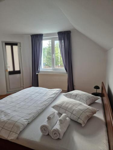 a bedroom with two beds with towels on them at COM Home Sovata in Sovata