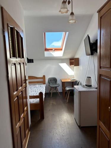 a room with a window and a table and a chair at Marszałek Mielno in Mielno