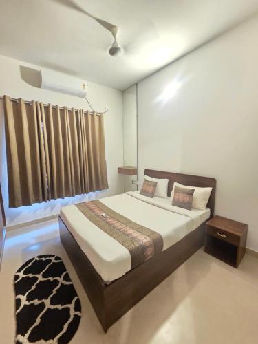 a bedroom with a bed and a window at Aqua blue bay villa in Covelong