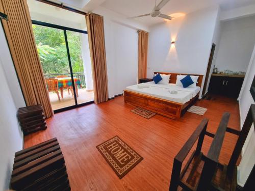 a bedroom with a bed with blue pillows on it at Ella Mist Haven in Ella