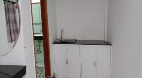 a small white bathroom with a sink and a mirror at Unique Hotel in Phnom Penh