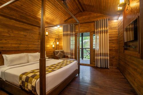 a bedroom with a bed in a wooden room at TSG Aura in Neil Island