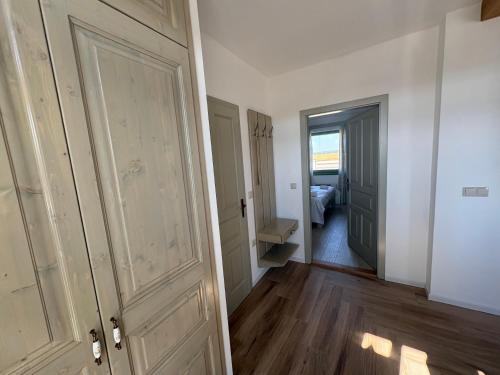 an empty room with a door and a bedroom at Levendula Apartman in Buzsák