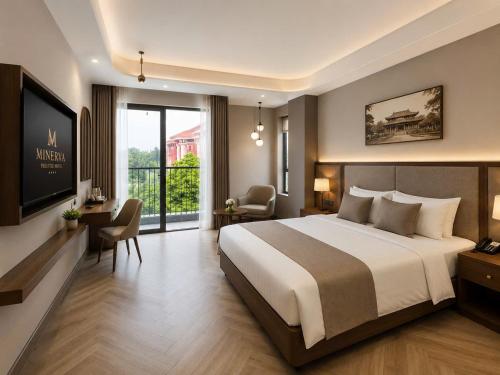a bedroom with a large bed and a balcony at Minerva Prestige Hotel in Hanoi