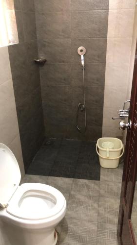 a bathroom with a toilet and a shower at Traditional Villa Munnar in Anachal