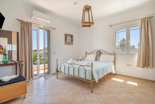a bedroom with a bed and a balcony at Agis Luxury House in Lefkada
