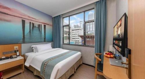 a bedroom with a large bed and a large window at Zhenxing Hotel in Shenzhen