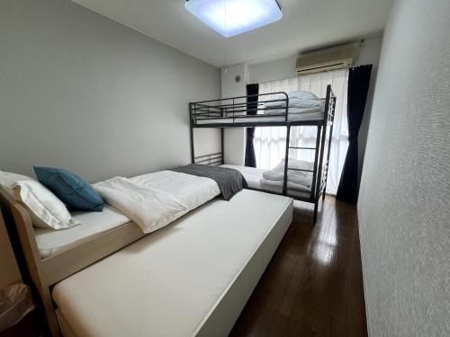 a bedroom with two bunk beds and a window at Apartment in Narita 123 in Narita