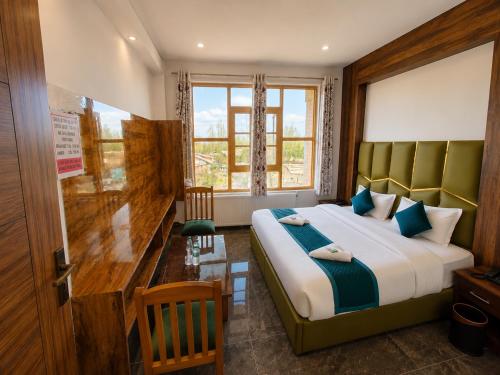 a bedroom with a large bed and a window at Gulmarg GS Residency Hotel in Gulmarg