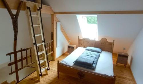 a bedroom with a bunk bed and a ladder at Erlebnishof Steinkellnergut in Henndorf