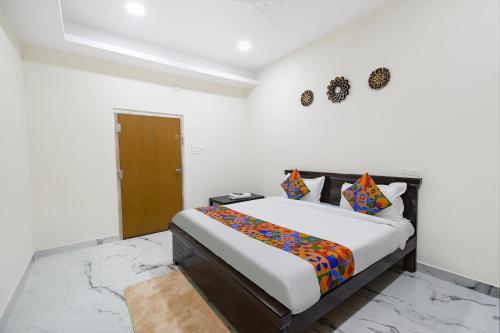 a bedroom with a large bed in a room at FabHotel Latitude in Hyderabad