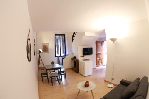 a living room with a couch and a table at Palazzo Velli Suites in Rome