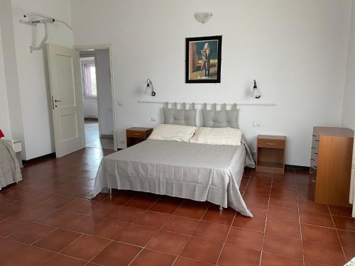 a bedroom with a bed and a tile floor at The River in Fordongianus