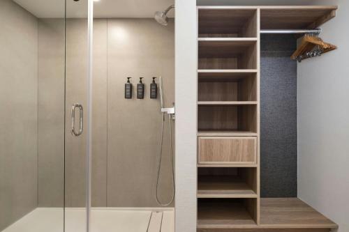 a shower in a bathroom with a glass door at Sheraton Pentagon City in Arlington