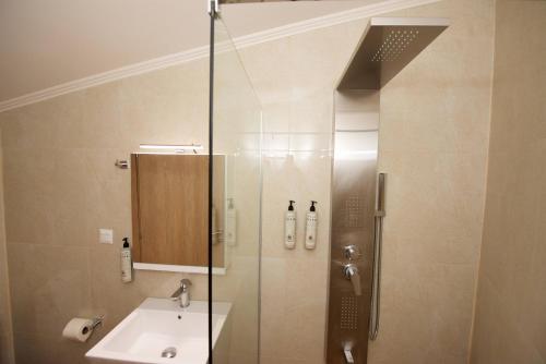 a bathroom with a shower and a sink at Nina's House by CorfuEscapes in Doukádes