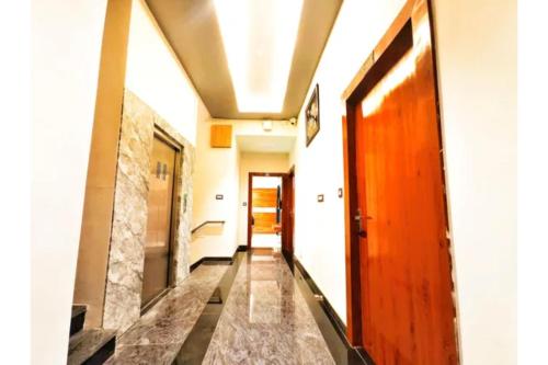 a hallway with a wooden door in a building at FabHotel The Crystal in Udaipur