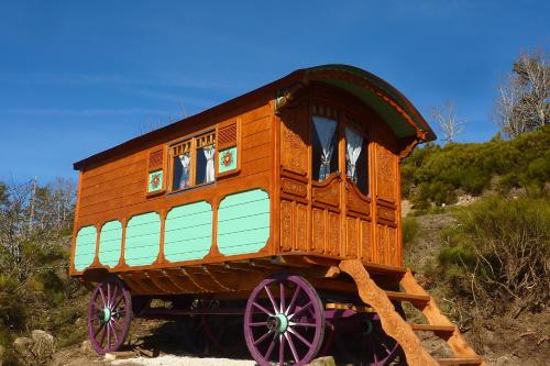 a wooden train car sitting on top of a hill at La Bergerie du Plateau in Cros-de-Géorand