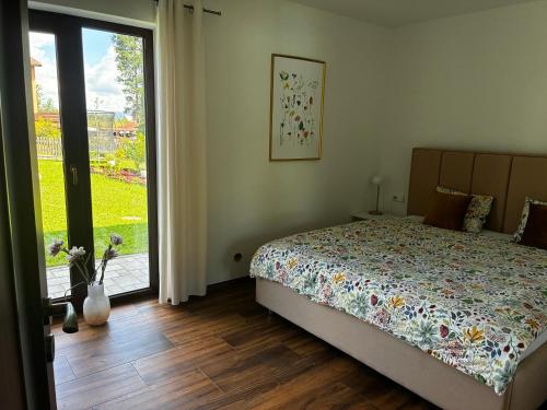 a bedroom with a bed and a sliding glass door at Prázdninový dům MAJKA in Mosty u Jablunkova