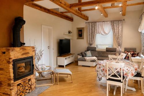 a living room with a couch and a fireplace at Unique Mailo House & Cottage in Riga