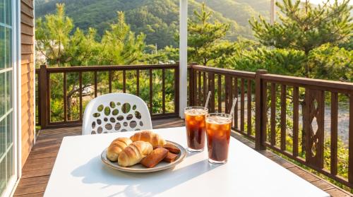a table with a plate of food and drinks on a balcony at Hwacheon Turkey Valley in Hwach'ŏn