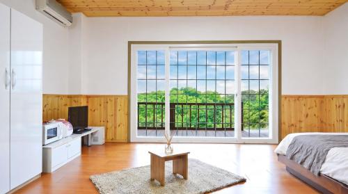 a bedroom with a bed and a large window at Hwacheon Turkey Valley in Hwach'ŏn
