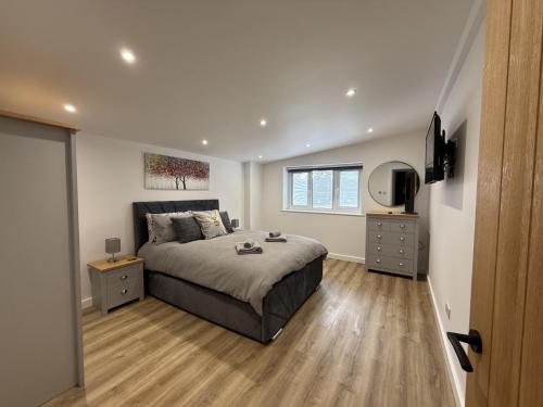 a bedroom with a bed and a television in it at Crossways Sycamore in Grimsby