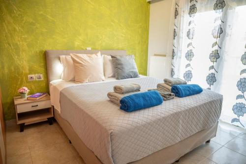 a bedroom with a bed with towels on it at Erato Superior Suite in Kremasti