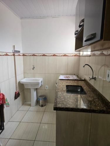 a small bathroom with a sink and a toilet at CasaPraiaSol1 in Rio das Ostras