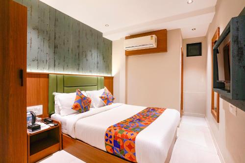 a hotel room with a bed and a television at FabHotel Ruby Grand in Mumbai